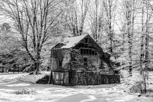 A black and white photo of an old barn in Ulster Park after a snow storm.