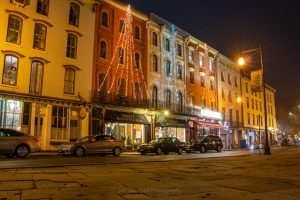 A nighttime photo of the storefronts along West Strand St. at the Kingston Rondout Historic Waterfront District.