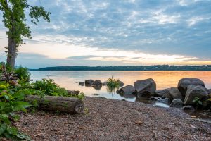A photo of a sunrise along the shore of the Hudson River on a June morning at Lighthouse Park.