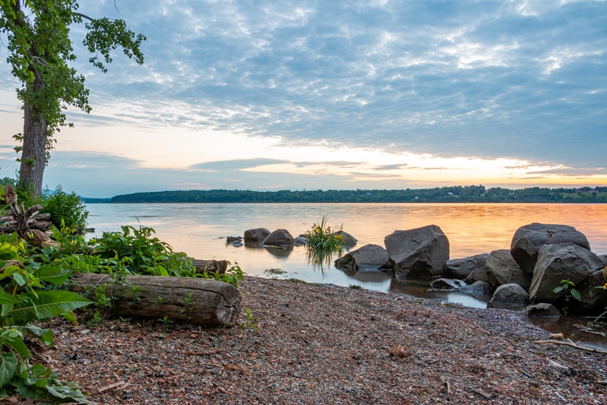 A photo of a sunrise along the shore of the Hudson River on a June morning at Lighthouse Park.