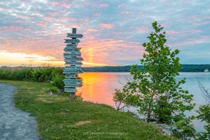 A fiery sunrise behind directional signs at Esopus Meadows Preserve in Ulster Park.