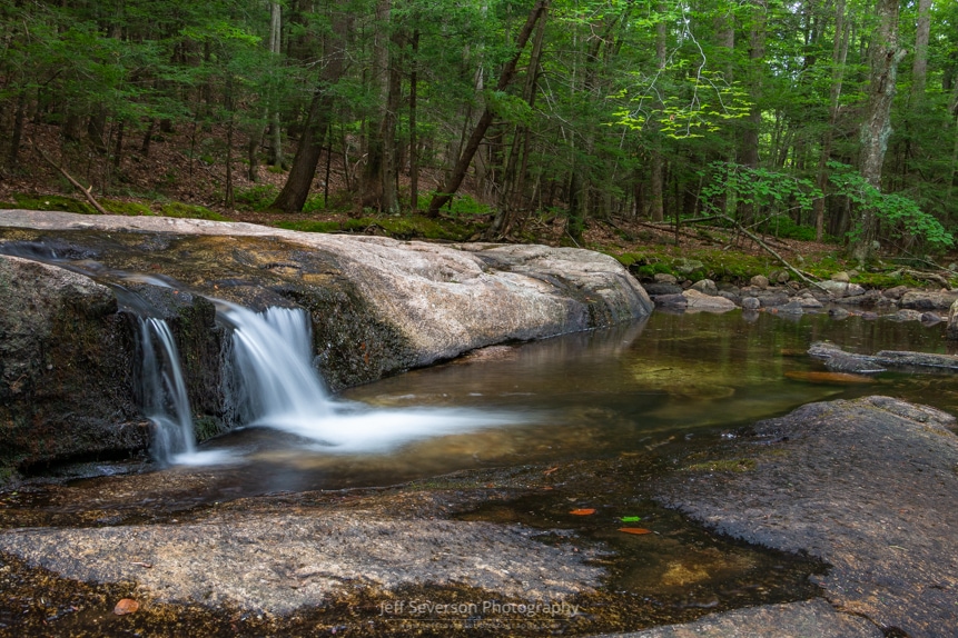 A long exposure photo of a mini waterfall along the Coxing Kill at Mohonk Preserve in Gardiner, NY.