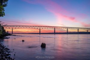 A photo of a June sunrise over over the Hudson River's Kingston-Rhinecliff Bridge.