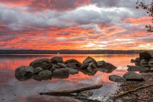 A photo of an orange sky over the Hudson River at sunrise on the first morning of November.