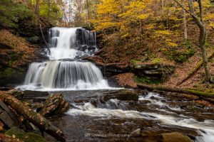 A photograph of the 47 foot Tuscarora Falls at Ricketts Glen State Park in PA on an autumn morning.