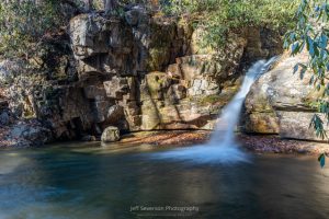 A photo of a 15-20 foot waterfall, the third of four cascading waterfalls, at the Blue Hole in Elizabethton, TN on a November morning.