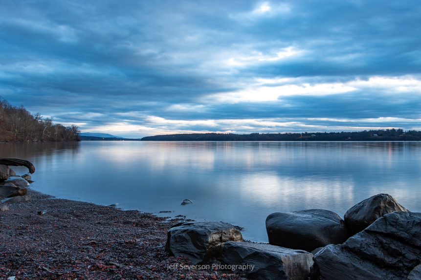 A shot of a cloud covered dawn over the Hudson River at Lighthouse Park in Ulster Park during the blue hour before sunrise.