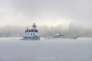 The yacht known as 'Arriva' passing by the Esopus Lighthouse as it sails down the Hudson River on a foggy October morning.