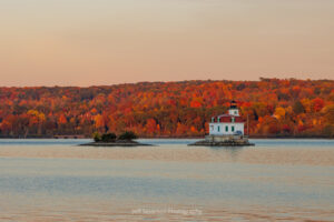 The Esopus Lighthouse and east coast of the Hudson River during the final minutes of the golden hour of sunset on an October evening.