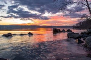 Sunrise over the Hudson River on the second morning of 2023 as waves roll in along the shore of Lighthouse Park after a ship passes.