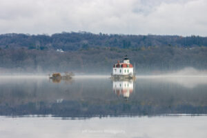 A photo of light fog on the Hudson River surrounding the Esopus Lighthouse.