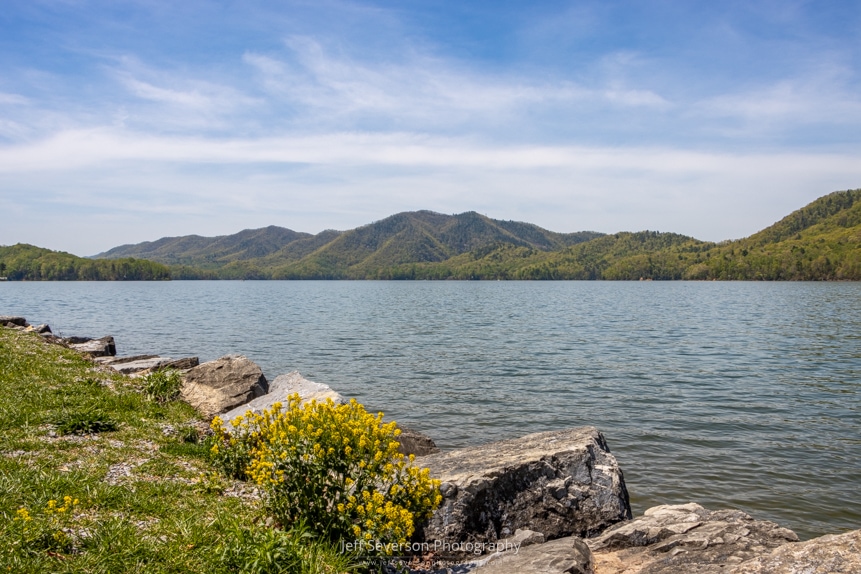A landscape photo looking West over Lake Watauga and at the surrounding mountains from the shores of Watauga Point in Hampton, TN.