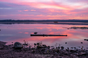 A photo of a pink and purple sunrise over the Hudson River in Ulster Park, NY.