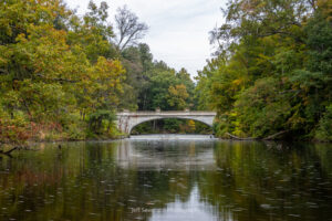 A photo of White Bridge spanning the Crum Elbow Creek at the Vanderbilt Mansion National Historic Site in Hyde Park, NY on a cloudy October morning.
