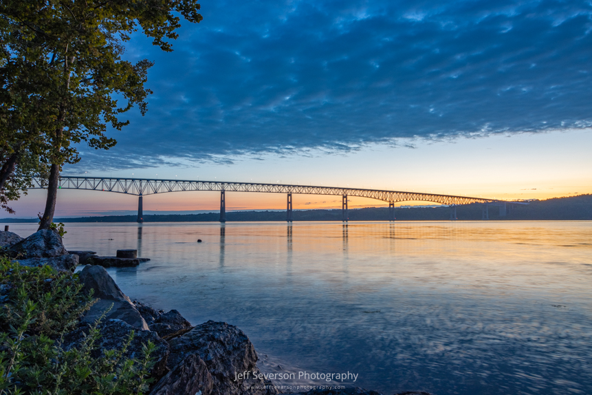 Dawn breaking over the Kingston-Rhinecliff Bridge and the Hudson River on a September morning from along the shore of Charles Rider Park.