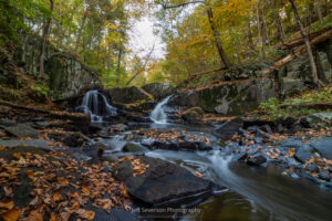 A long exposure photo of Black Creek and Middle Falls surrounded by fall foliage in early in October in Highland, NY.