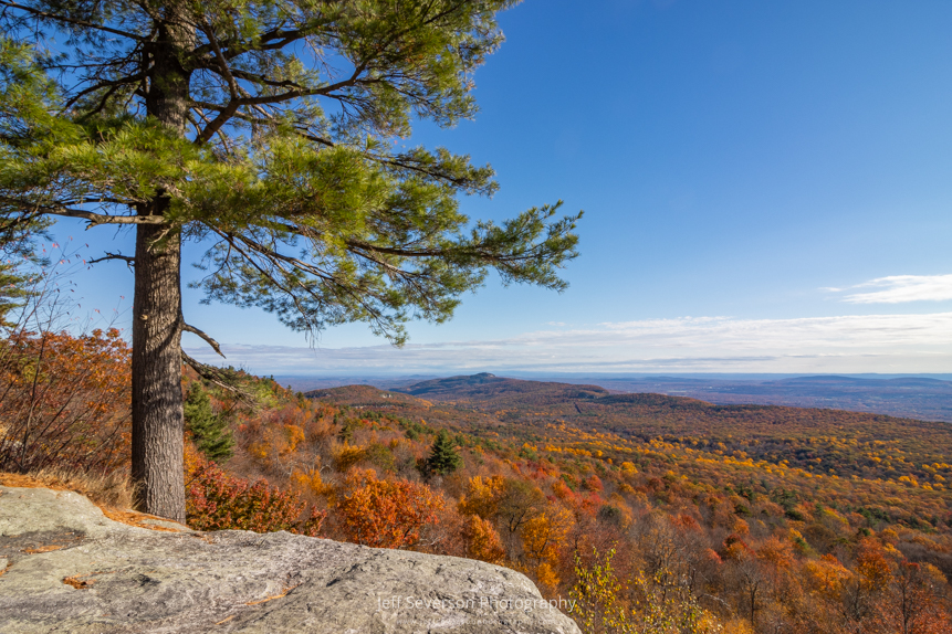 A landscape photo of the Hudson Valley from atop a cliff face at Minnewaska State Park Preserve in Kerhonkson on an October morning.