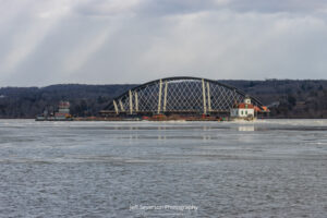 A section of the Portal North Bridge passing by the Esopus Lighthouse as it's escorted down the Hudson River to the Hackensack River in New Jersey.