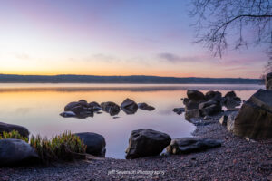 An April sunrise over the Hudson River from along the shoreline of Lighthouse Park in Ulster Park, NY.